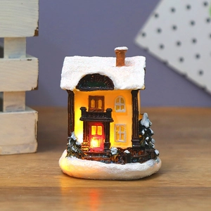 LED lighted Christmas resin house figurine with warm yellow glow and snow glitter finish