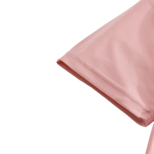 Detail of pink polo shirt sleeve featuring breathable pique mesh fabric and reinforced stitching