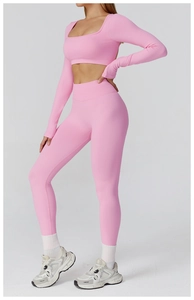 Pink seamless yoga set with long sleeve crop top and high waisted leggings for workout