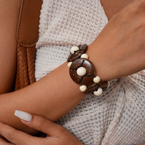 Close-up of Bohemian wood and coconut shell beaded bracelet on female wrist