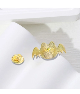 Detail view of the metal butterfly clutch back and pin of the cat-shaped golden brooch