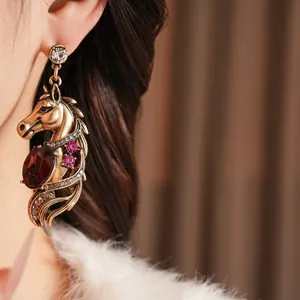 Vintage horse head earrings with red drop stone and silver needle studs in gold finish