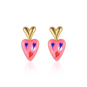 Detail of heart earrings with gold top and pink enamel pattern reflecting on white