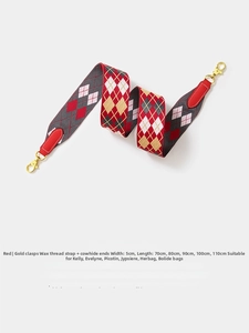 Detail of 5cm wide red and gold geometric woven strap with leather ends and metal hooks