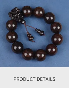 Macro detail of dark sandalwood beads with Pixiu carving on blue textured fabric