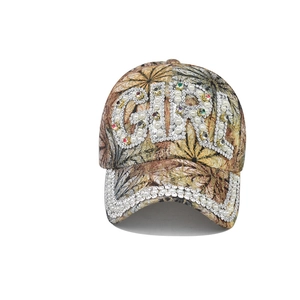 Detail of Girl lettering made of pearls and colorful rhinestones on a floral baseball cap