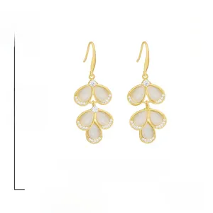 Detail of gold-tone leaf earrings with opal teardrops and crystal accents