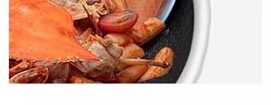 Close-up of ebony wood spatula cooking crab and sausages in a non-stick honeycomb pan