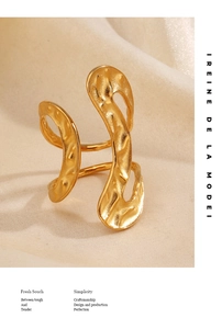 Macro detail of irregular hammered texture on a 18k gold plated stainless steel ring