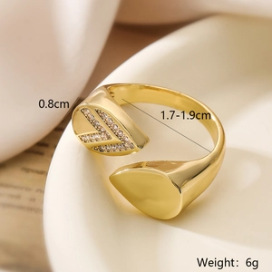 Macro shot of gold-plated geometric leaf ring with zircon accents and size dimensions