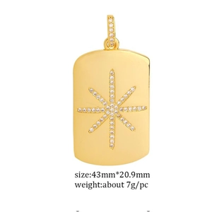 Macro view of gold plated rectangle pendant featuring a diamond-set North Star design