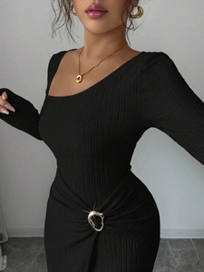 Close-up of black textured fabric dress with elegant silver metal buckle detail at waist