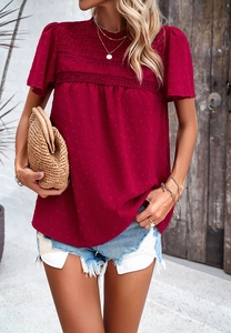Detail of burgundy short sleeve chiffon top featuring Swiss dots and delicate lace trim