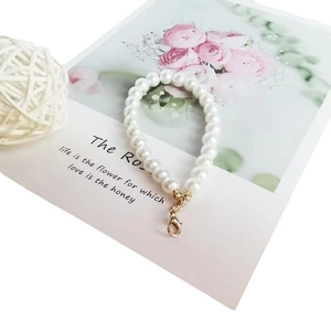 Short pearl charm chain with gold lobster clasp on elegant floral decorative card