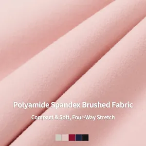 Close-up of pink brushed yoga bra fabric featuring four-way stretch and soft texture