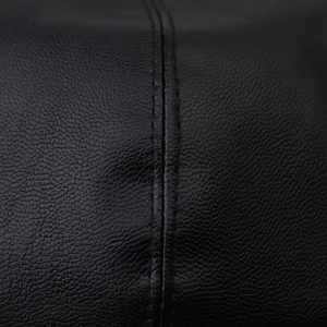 Detailed macro view of black PU leather beret showing double stitching and lychee grain texture