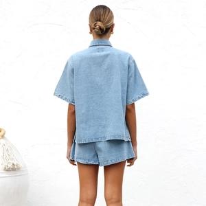 Back view of a loose light blue denim set with short-sleeved shirt and cuffed shorts
