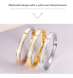 Detailed view of 18K gold plated bangles with white enamel inlay and zircon accents
