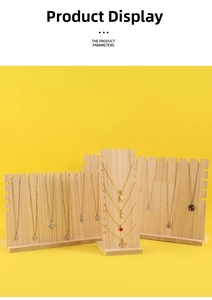 Detail view of gold and silver pendants displayed on a rustic wooden jewelry stand