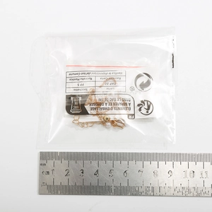 Close-up of gold pearl necklace with rhinestone pendant and measuring ruler for size scale