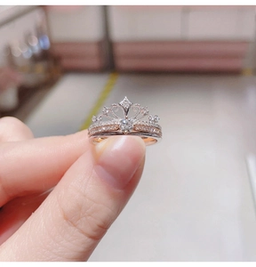 Macro shot of silver and rose gold crown ring set with zircons and large center stone