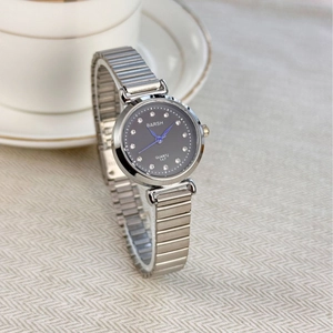 Elegant silver steel watch with black rhinestone dial displayed near a white teacup