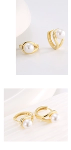 Detail view of 14K gold plated silver hoop earrings with white shell pearl inlay