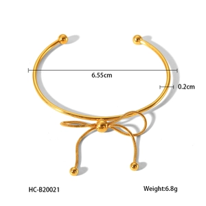 Detail view of 18K gold stainless steel bow cuff bracelet with 6.55cm inner diameter