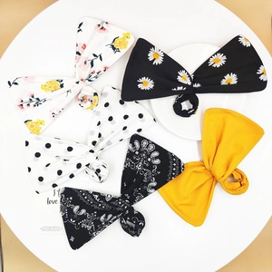 Bow hair bun maker clips in five floral patterns including daisy and polka dot styles
