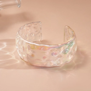 Detail of holographic acrylic cuff bracelet with hammered water ripple texture