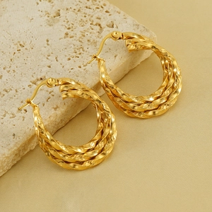 Twisted multi-layer 18K gold plated stainless steel hoop earrings on stone display