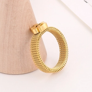 Detailed macro view of an 18K gold mesh woven ring with a polished T-shaped centerpiece