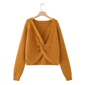 Chic mustard yellow knit sweater with stylish front twist knot and elegant V-neckline