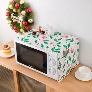 Detail of Christmas microwave dust cover with side storage pocket and pom pom fringe