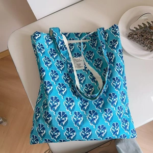 Macro detail of tulip print cotton tote bag with vintage indigo floral pattern and tag