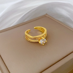 Adjustable gold plated cross ring with sparkling zircon stone on brown leather gift box