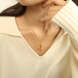 Elegant gold rose pendant necklace in titanium steel on model, minimalist vintage jewelry