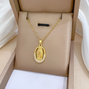 Detailed close-up of golden oval portrait pendant with sparkling zircon accents