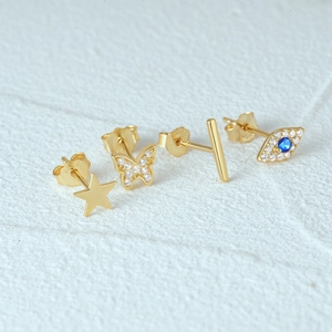 Detailed macro view of S925 sterling silver gold-plated stud earrings set with zircon details