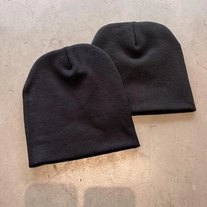 Set of two minimalist black knit beanies made of thick textured wool for winter style