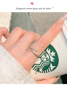 Silver snake-shaped ring with pavé cubic zirconia details worn on a finger