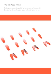 Detail of long coffin press-on nails with orange gradient, black butterflies and gold glitter