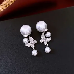 Exquises boucles d'oreilles papillon en perles plaquées or 18 carats avec accents brillants