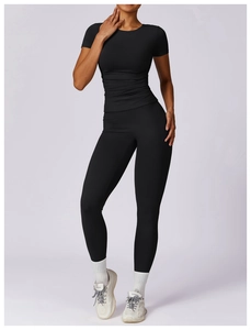 Close-up of black quick-dry yoga set featuring slim short-sleeve top and high-waist leggings