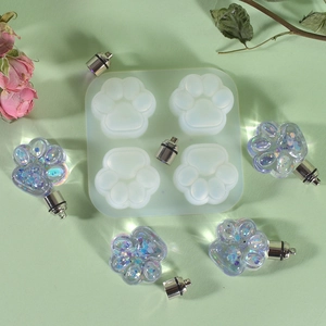 Macro detail of 4-cavity cat paw silicone mold with glitter resin crafts and flowers