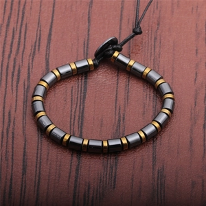 Minimalist beaded bracelet for men with black hematite stone cylinders and gold spacers