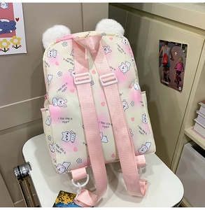 Detail of pink gradient plush bunny backpack with adjustable straps and fluffy pom-pom ears