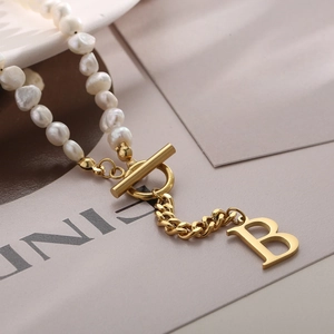 Elegant gold chain necklace with irregular pearls and a letter B pendant with OT clasp