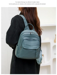 Detail of dark green PU leather backpack with silver hardware and front flap pocket