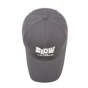 Dark grey baseball cap with white SLOW embroidery on a minimalist white background